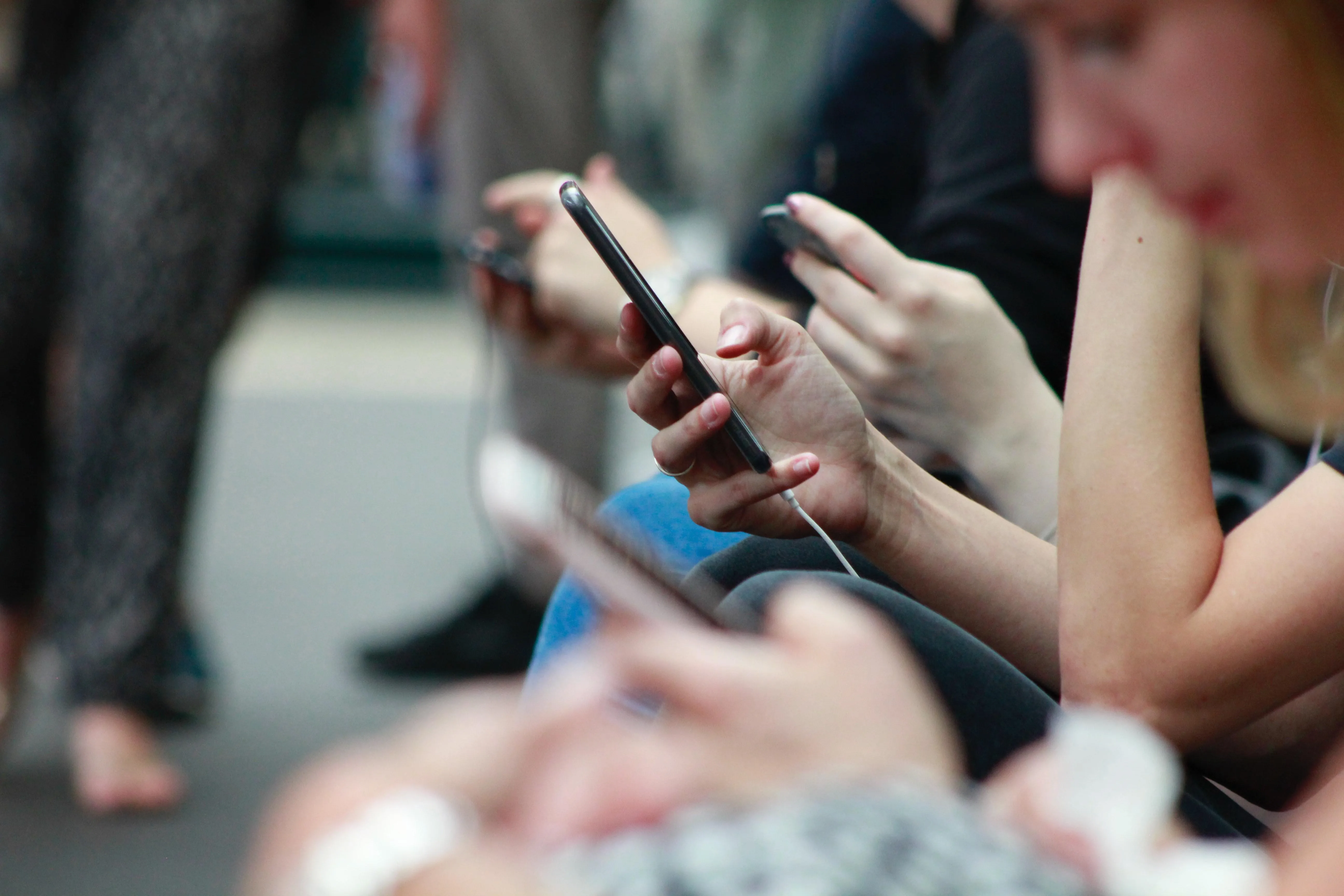 group of people using their mobile devices