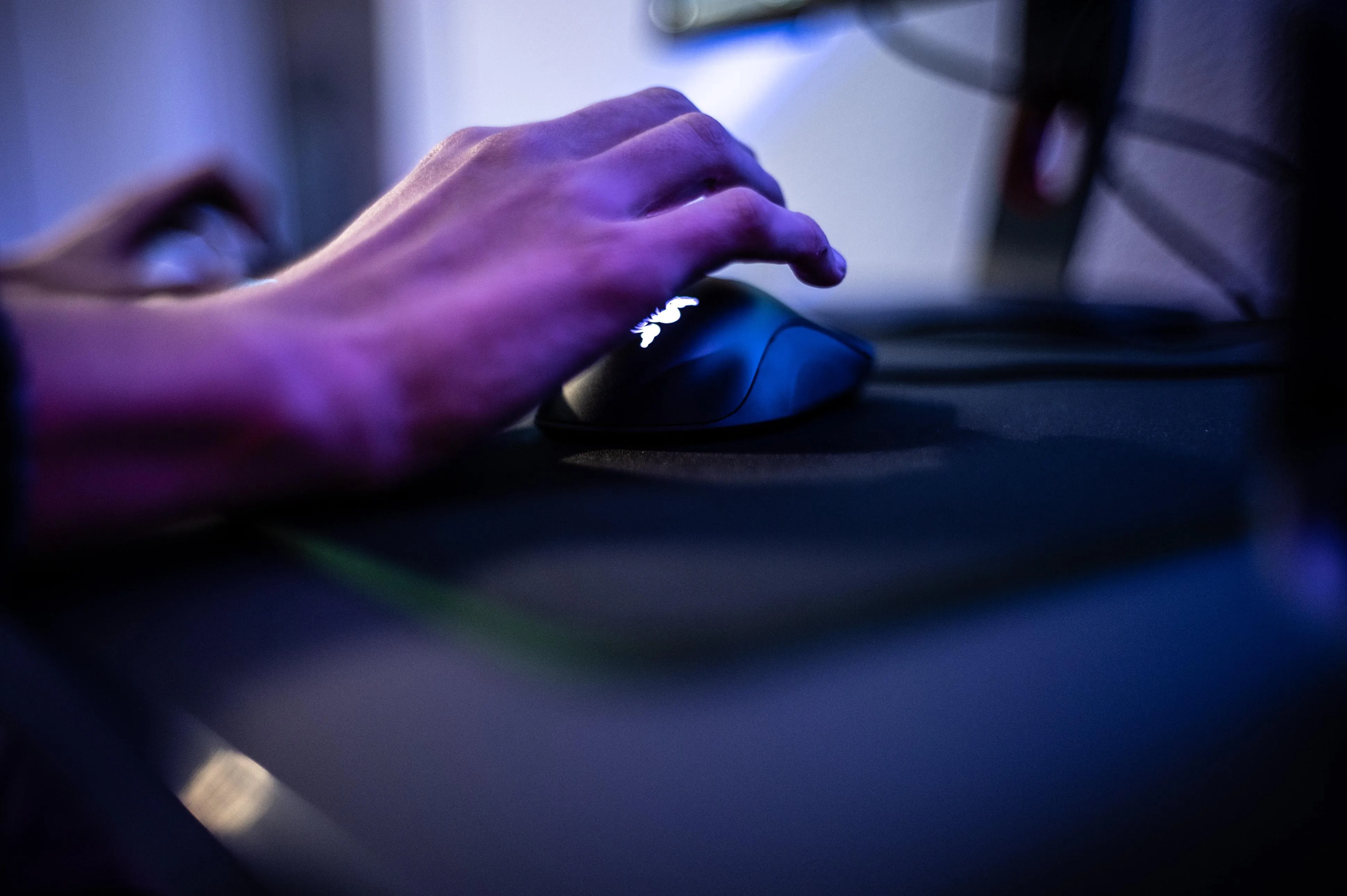 person's hand hovering over a computer mouse